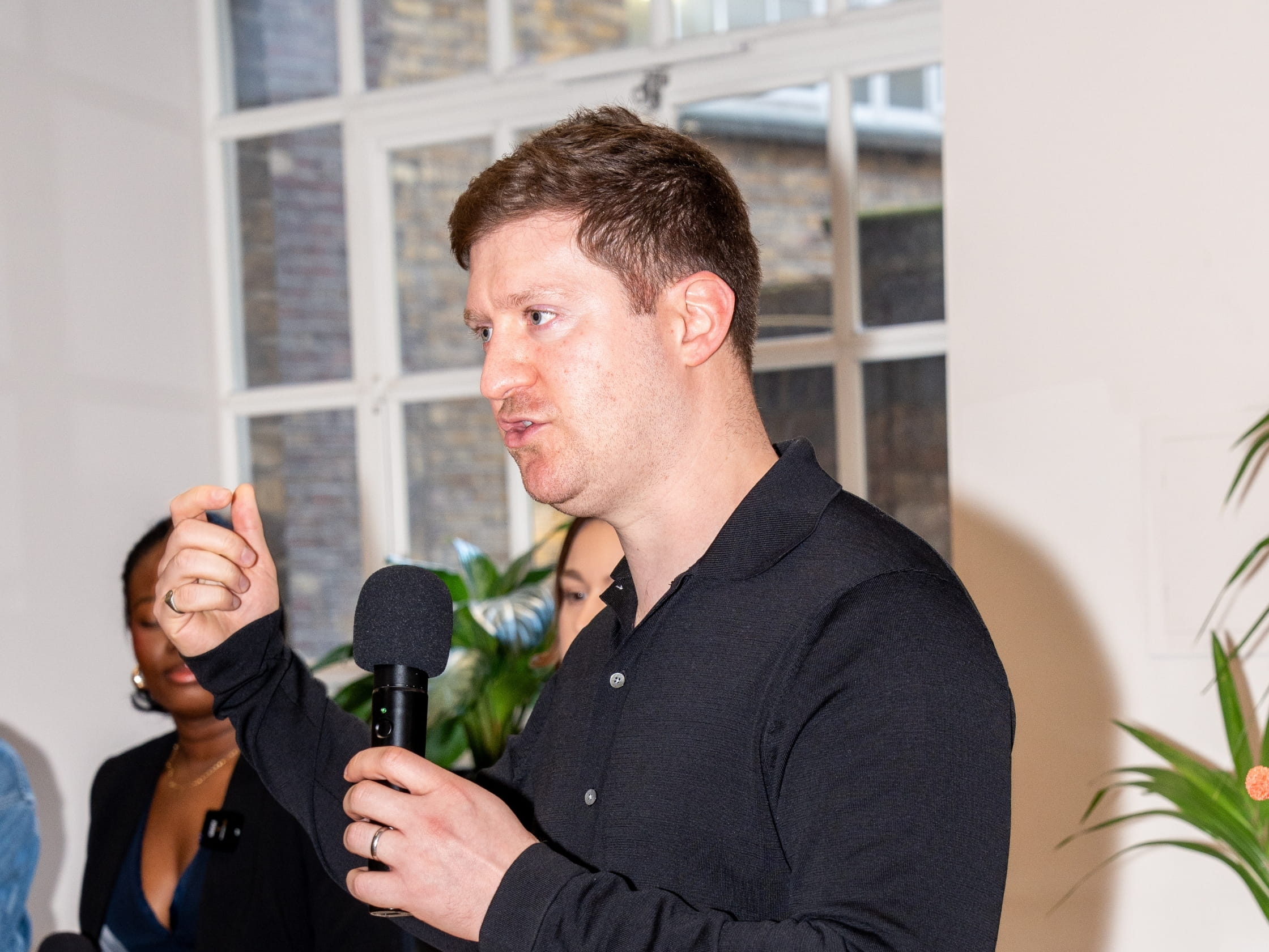 A man speaking into a microphone.