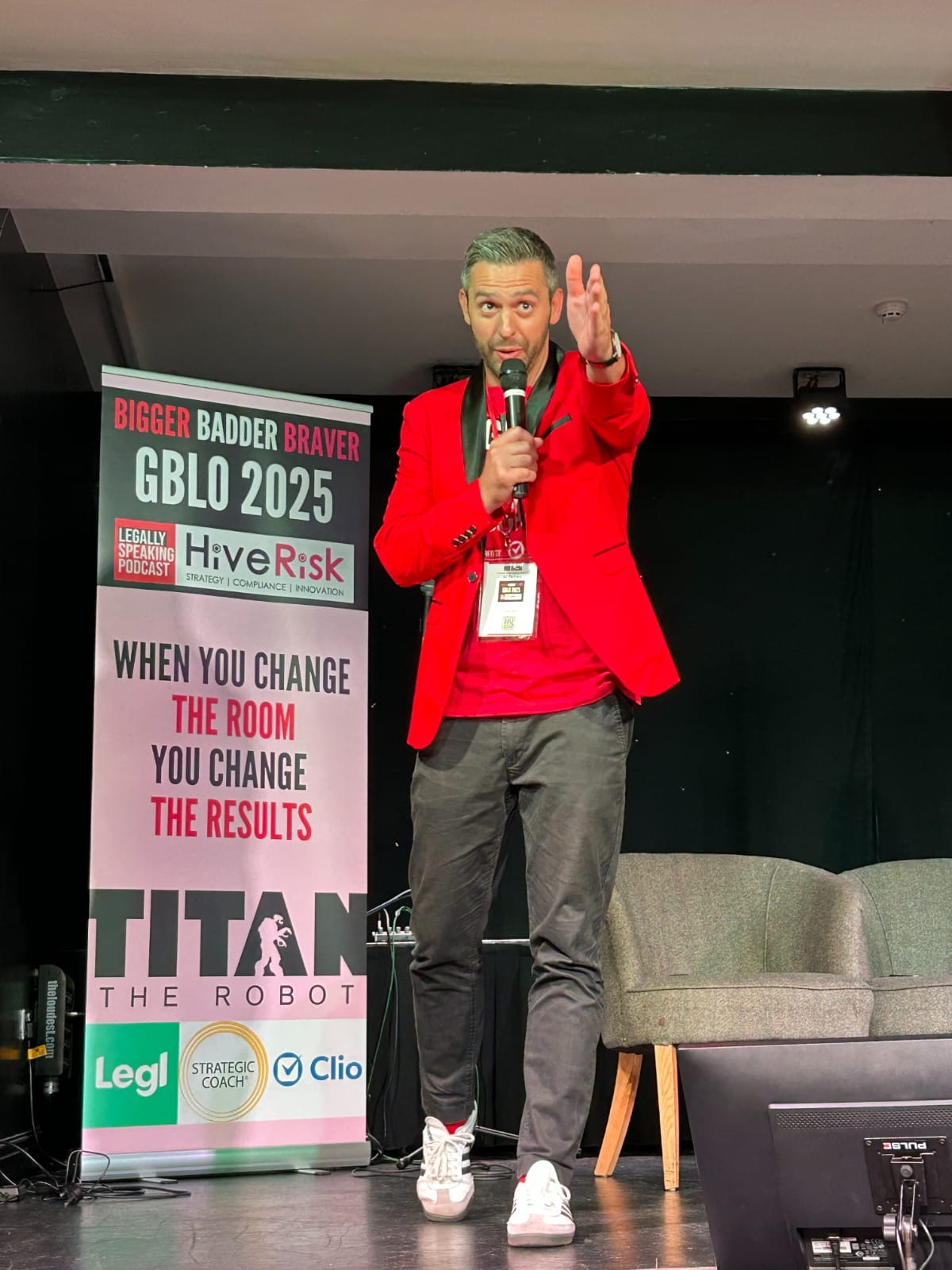 Robert Hanna speaks on stage at an event.