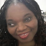 Placida has black hair and is smiling. 