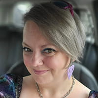 Kirsty is a white woman with silver hair.