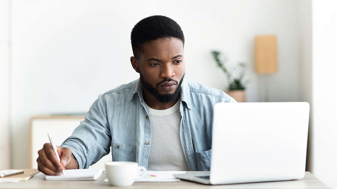 Man using laptop to search and apply for jobs