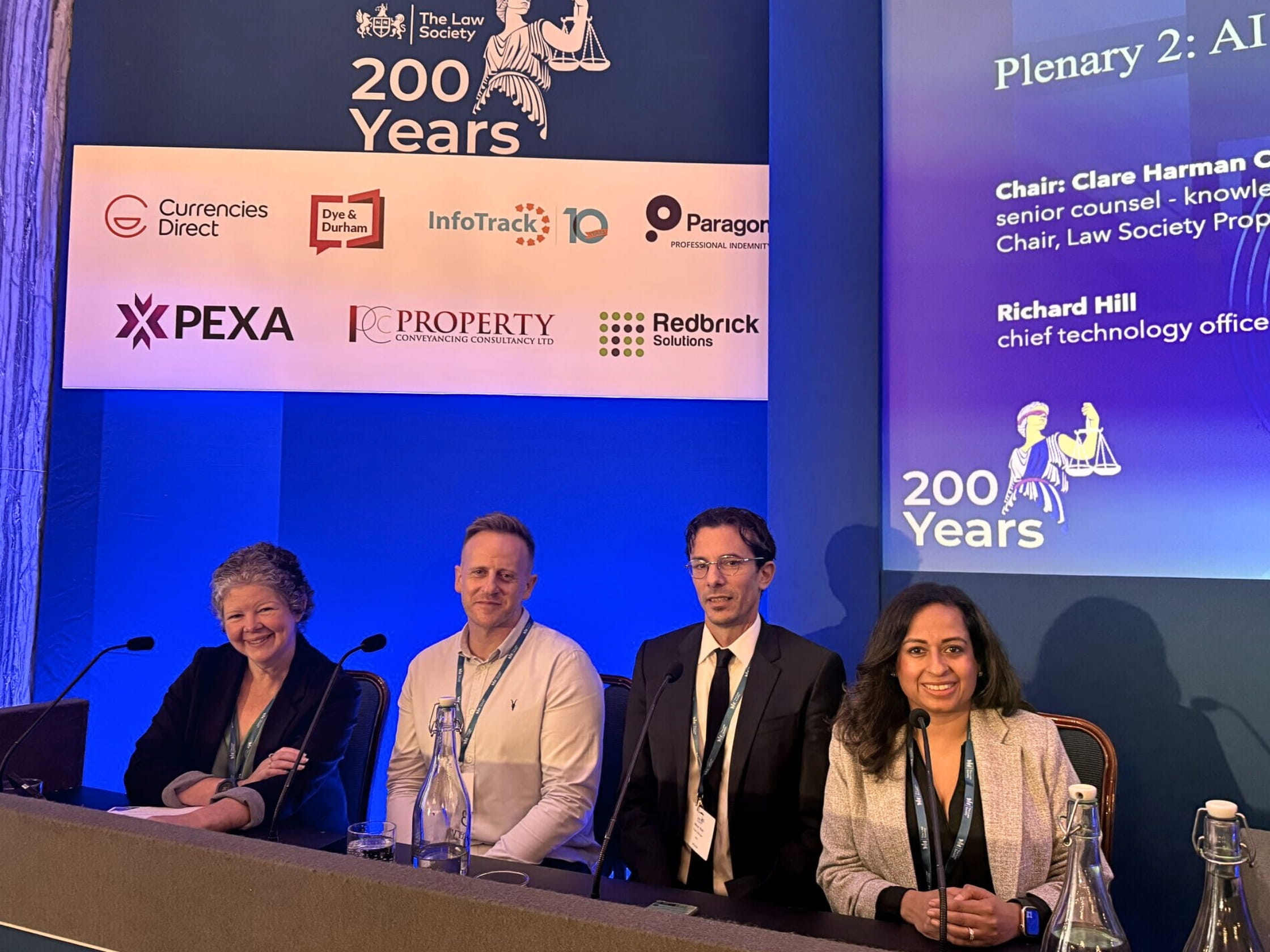 A panel of four people at a Law Society conference event.
