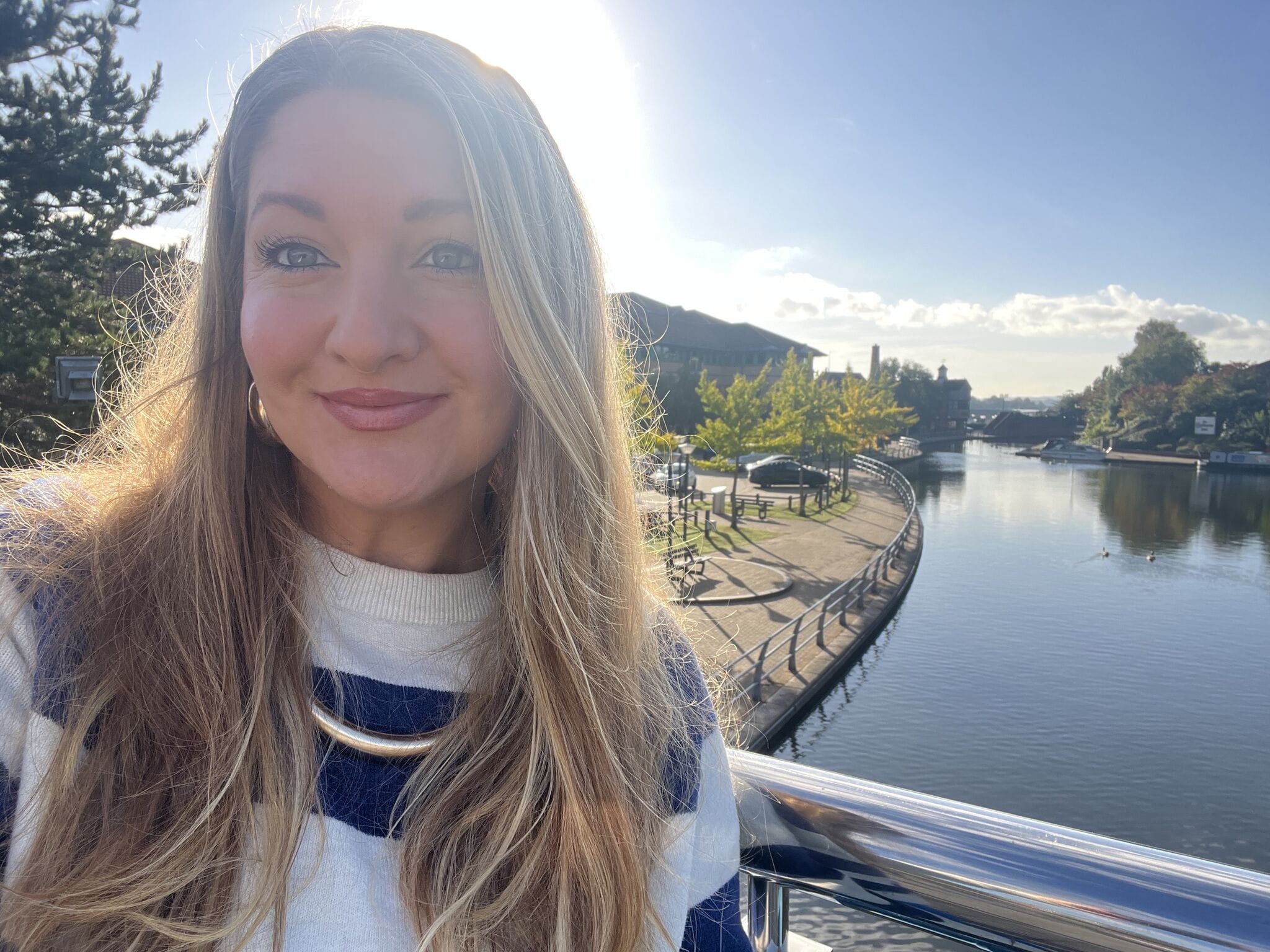 Solicitor Emma Chater smiles for a selfie in front of a river