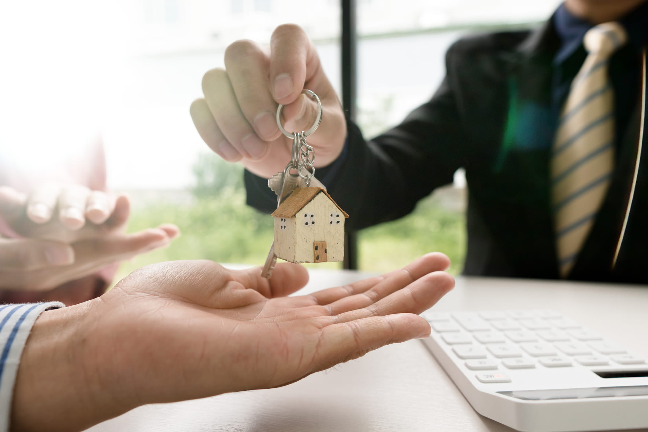 solicitor-handing-house-keys-to-a-couple