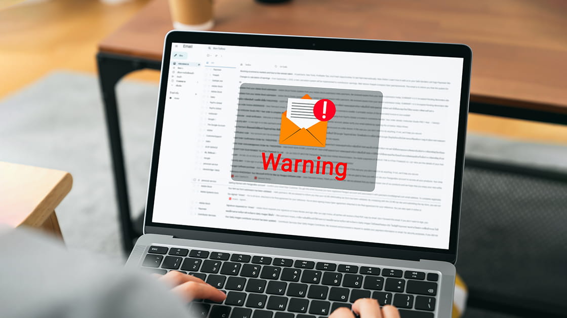 A scam warning alert displays on an email inbox.