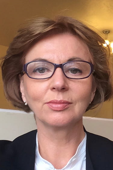 Karen Ridge is a white woman with short hair, wearing glasses