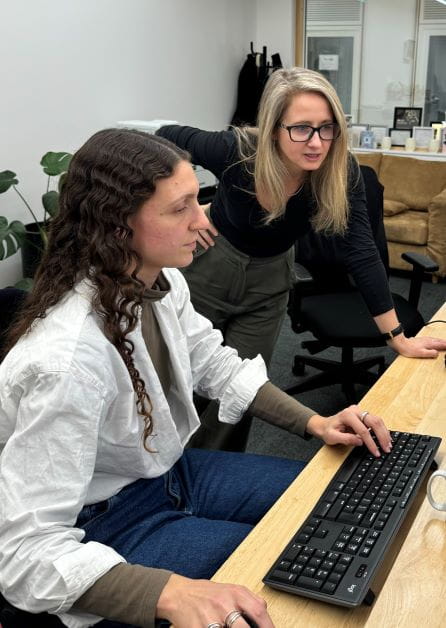 A solicitor works on a keyboard alongside Anne-Marie Irwin. Photographer: Jennifer Wright