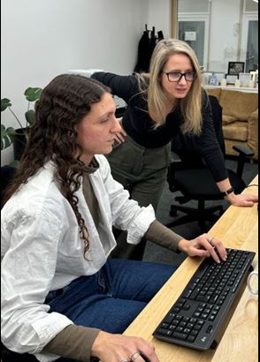 A solicitor works on a keyboard alongside Anne-Marie Irwin. Photographer: Jennifer Wright