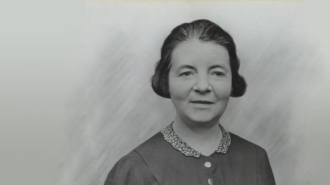 Black and white photograph of Carrie Morrison, a white woman with dark hair pinned up, wearing a dark buttoned dress with lace collar (1920s)