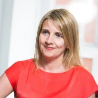 Liz Turner is a woman with shoulder length blonde hair, she is wearing business dress.