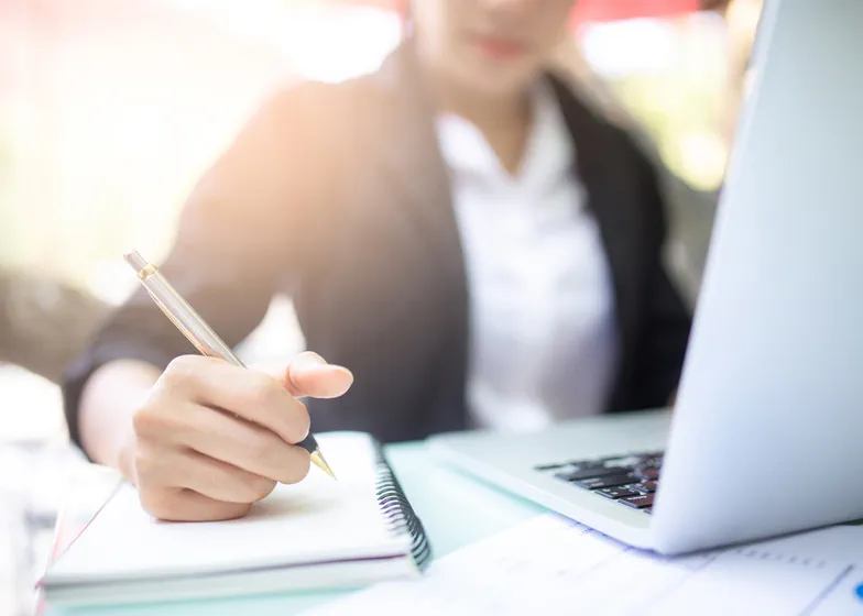 Person writing in a notepad