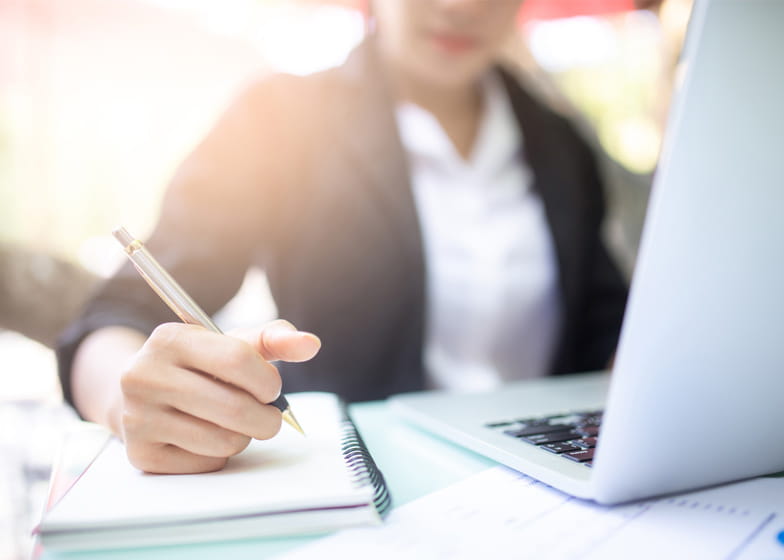 Person writing in a notepad